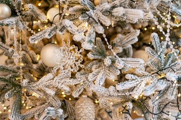 Christmas and New Year background, tree decorated with lights and crystal New Year decoration. Soft selective focus.