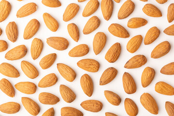 Almond pattern on beige background, top view, flat lay	