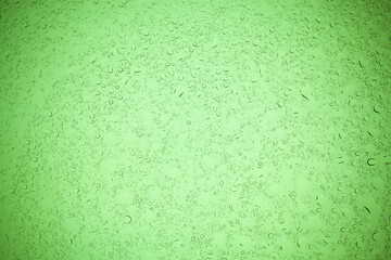 Rain droplets on green glass background, Water drops on green glass.