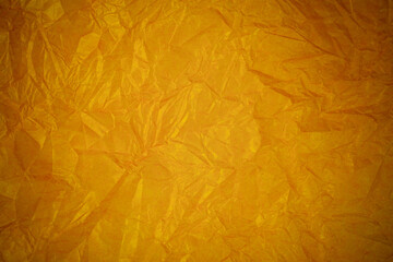 Crumpled gold paper recycling background.