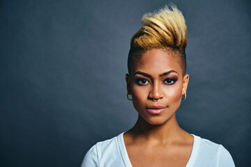 Portrait Of a confident Young Female Hipster with cool short hair and trendy nose ring and earrings