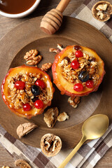 Concept of tasty food with baked apple on wooden background
