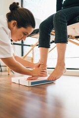 Chiropodist taking the shape of a patient's foot with a foam mold for the manufacture of a special insole.