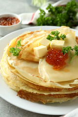 Concept of tasty food with crepes on gray textured background