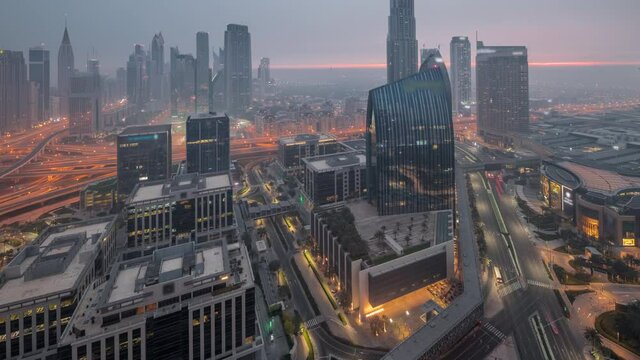 Futuristic Dubai Downtown and finansial district skyline aerial night to day timelapse.