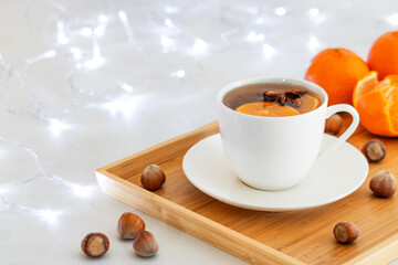 Hot fruit tea with anise star. Mandarins and hazelnuts. Christmas or New Year hot winter drink.