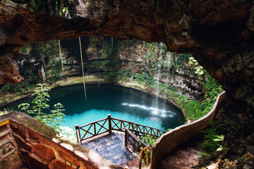 the blue water of the cenote of Yucatan in Mexico at a sunny day