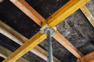 The supports of monolithic floor formwork at a construction site. Telescopic props for concrete...