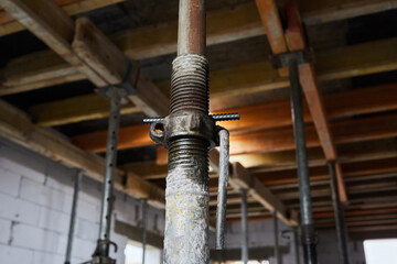 The supports of monolithic floor formwork at a construction site. Telescopic props for concrete...