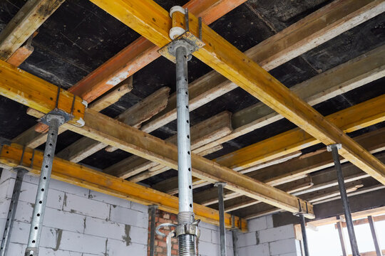The supports of monolithic floor formwork at a construction site. Telescopic props for concrete flooring. Construction of a modern apartment building 