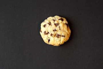 Chocolate chips cookie against black background. Photo taken December 29th, 2021, Zurich, Switzerland.