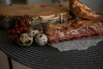 A delicious piece of meat cooked on the grill lies on a wooden board with berries