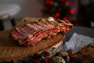 A delicious piece of meat cooked on the grill lies on a wooden board with berries