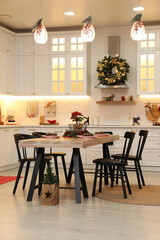 Cozy dining room interior with beautiful Christmas wreath and festive decor