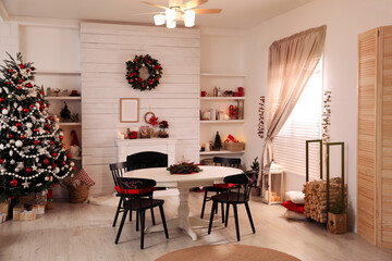 Cozy dining room interior with Christmas tree and festive decor