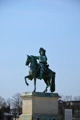 Fototapeta na wymiar Louis XIV statue in front of Versailles Palace, Paris (France)