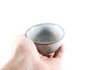 kintsugi gold cracks restoration, Japanese bowl fixed with the antique kintsukuroi restoration...