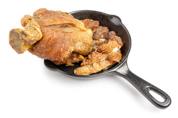 Homemade Crispy, Golden Deep Fried Pork Knuckle on black pan isolated on a white background. Clipping path.