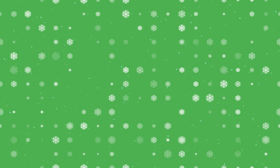 Seamless background pattern of evenly spaced white snowflake symbols of different sizes and opacity. Vector illustration on green background with stars