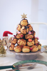 A traditional French croquembouche or pièce montée, with glass of white and festive atmosphere....