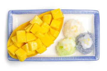 Fresh Ripe Thai Mango and Herbal Colored Sticky Rice, Authentic Thai Desserts topping with golden roasted beans and coconut milk served on a dish isolated on white background. Clipping path