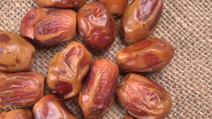 Dates in wooden bowl on background. dried dates fruit.