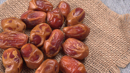 Dates in wooden bowl on background. dried dates fruit.