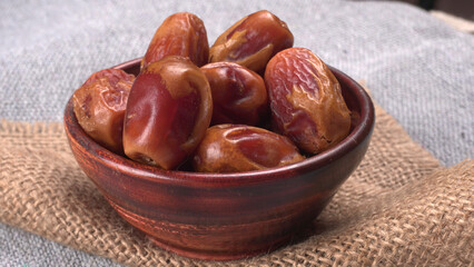 Dates in wooden bowl on background. dried dates fruit.
