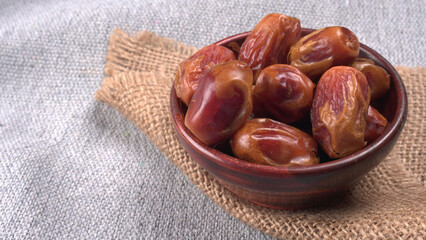 Dates in wooden bowl on background. dried dates fruit.