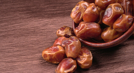 Dates in wooden bowl on background. dried dates fruit.
