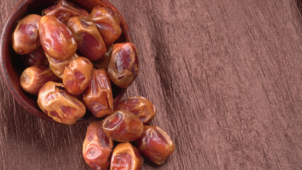 Dates in wooden bowl on background. dried dates fruit.