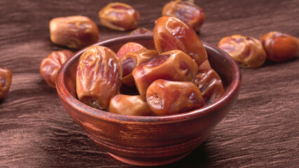 Dates in wooden bowl on background. dried dates fruit.