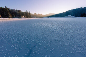 fin d'après-midi sur le lac Genin gelé en hiver dans le massif montagneux du Jura dans l'Ain en France