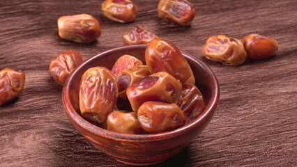 Dates in wooden bowl on background. dried dates fruit.