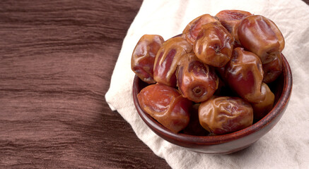 Dates in wooden bowl on background. dried dates fruit.
