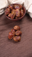 Dates in wooden bowl on background. dried dates fruit.
