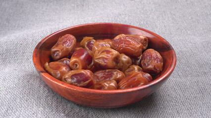 Dates in wooden bowl on background. dried dates fruit.