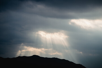 The sunlight shining through the clouds