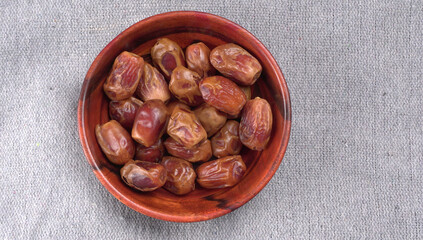 Dates in wooden bowl on background. dried dates fruit.