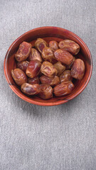 Dates in wooden bowl on background. dried dates fruit.