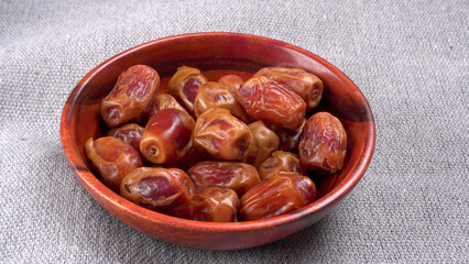 Dates in wooden bowl on background. dried dates fruit.