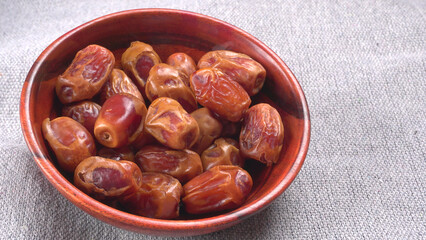 Dates in wooden bowl on background. dried dates fruit.
