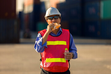 Industrial factory workers take a break to eat snacks and water.