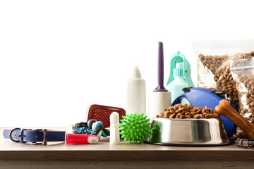 Food and accessories for the dog on wooden table isolated