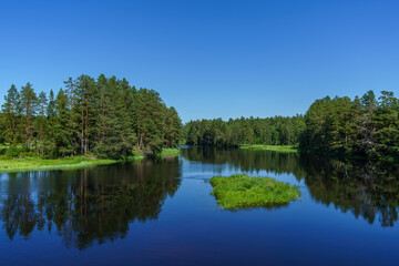 Fototapeta na wymiar Blue river flowing through a lush green landscape