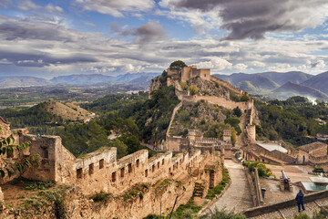 Fototapeta na wymiar The medieval castle of Xativa against a dramatic and bright sky after the rain. District of Valencia. Spain