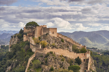 The medieval castle of Xativa against a dramatic and bright sky after the rain. District of...