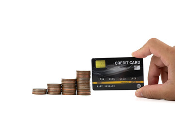 A man hand holding black credit card with coins stacking placed on the side isolated on white background, online shopping and banking concepts