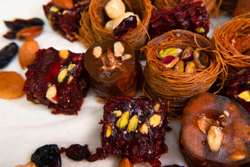 Traditional multi-colored arabic sweets baklava, lokum, muska pestili and nuts assortment. Top view.