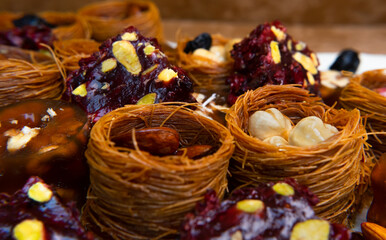 Traditional multi-colored arabic sweets baklava, lokum, muska pestili and nuts assortment. Top view.